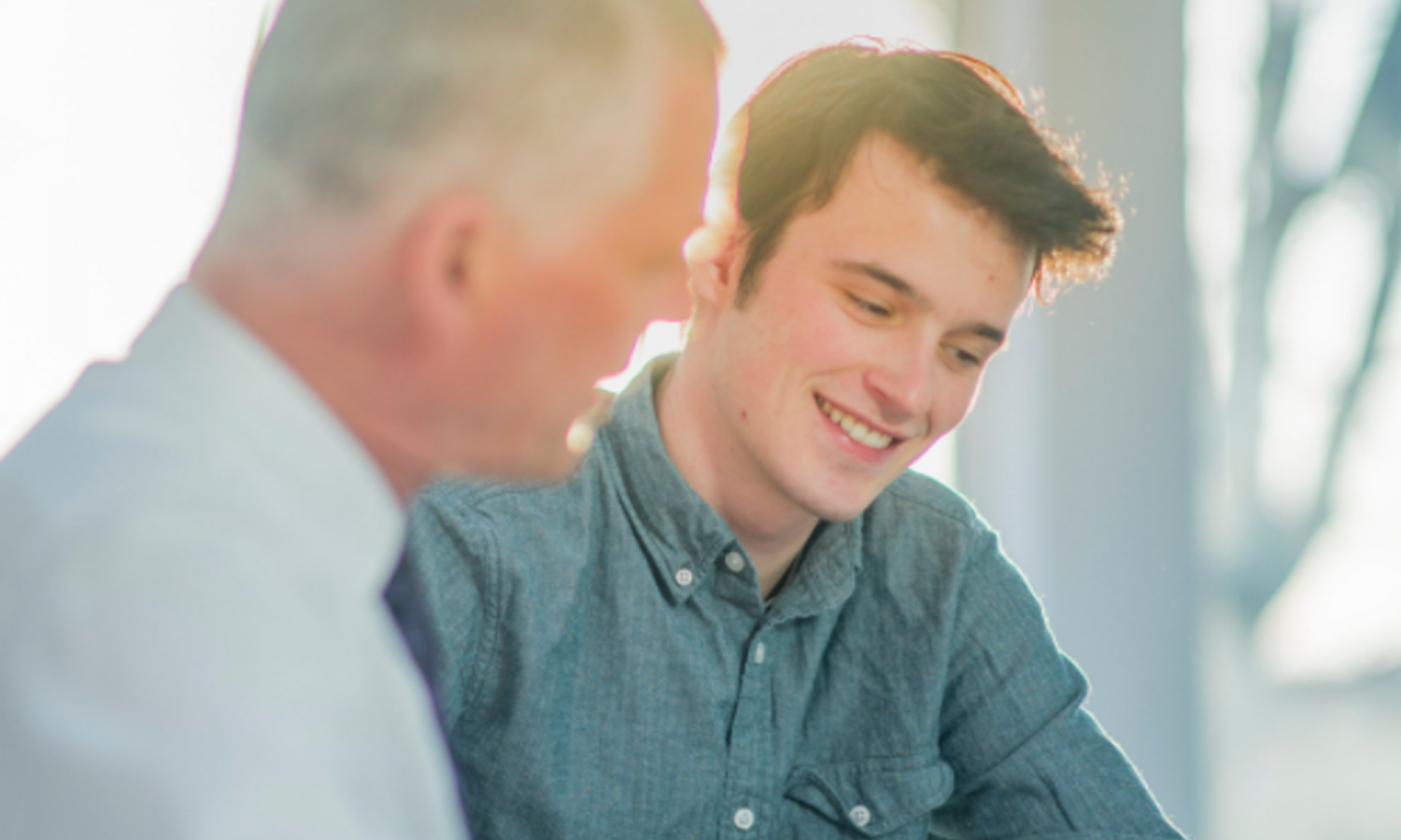 Older man and young man talking