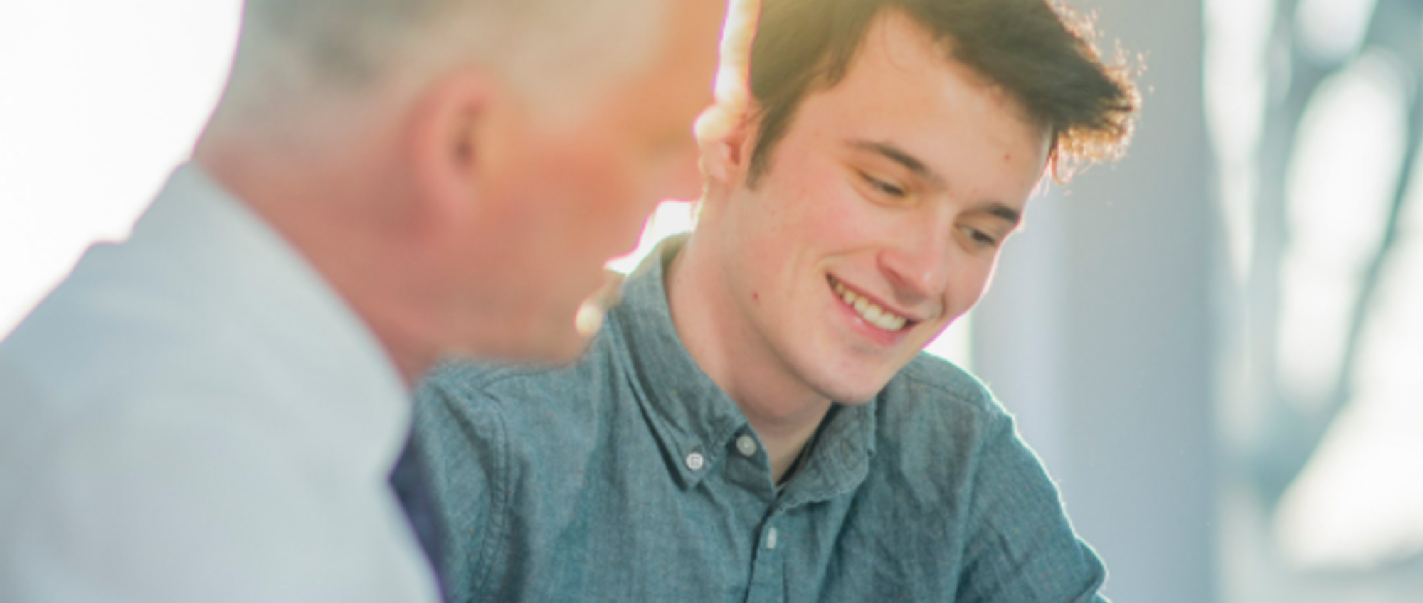 Older man and young man talking