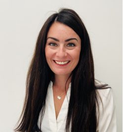 Photo of smiling women with dark brown hair.