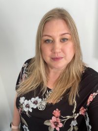 Photo of women with blond hair in floral top