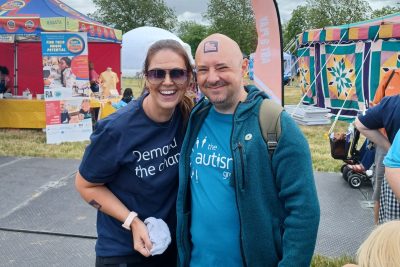 Becky is wearing a Demand the change Tshirt and is stood with a man who has his Demand the change tattoo on his forehead!