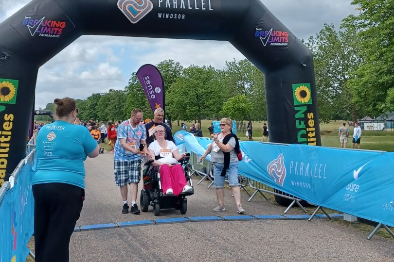 Kerry, DP100 influencer, crossing the finishing line in her chair.