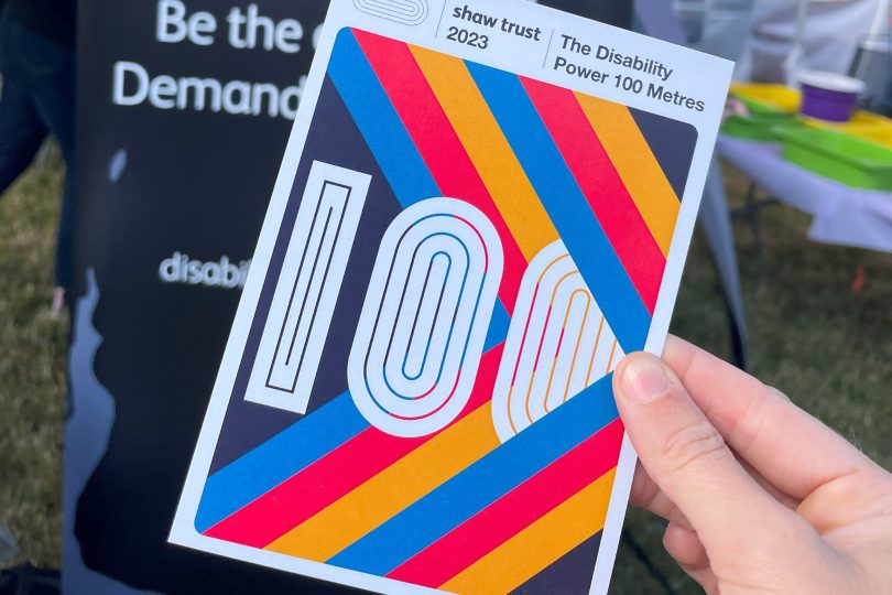 a retro, 70s inspired DP100 postcard with coloured stripes and 100 across the middle.