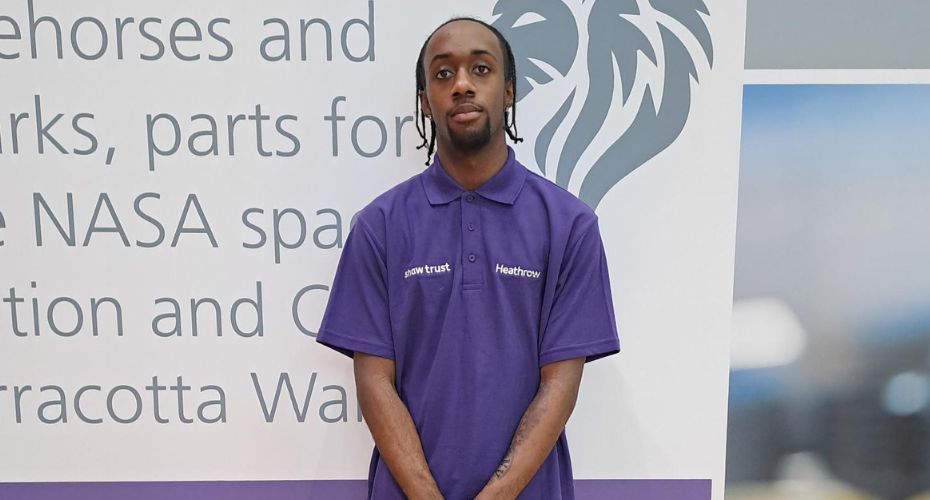 Man standing in front of board wearing a shaw trust top